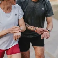Two runners starting the GPS on their Garmin watches
