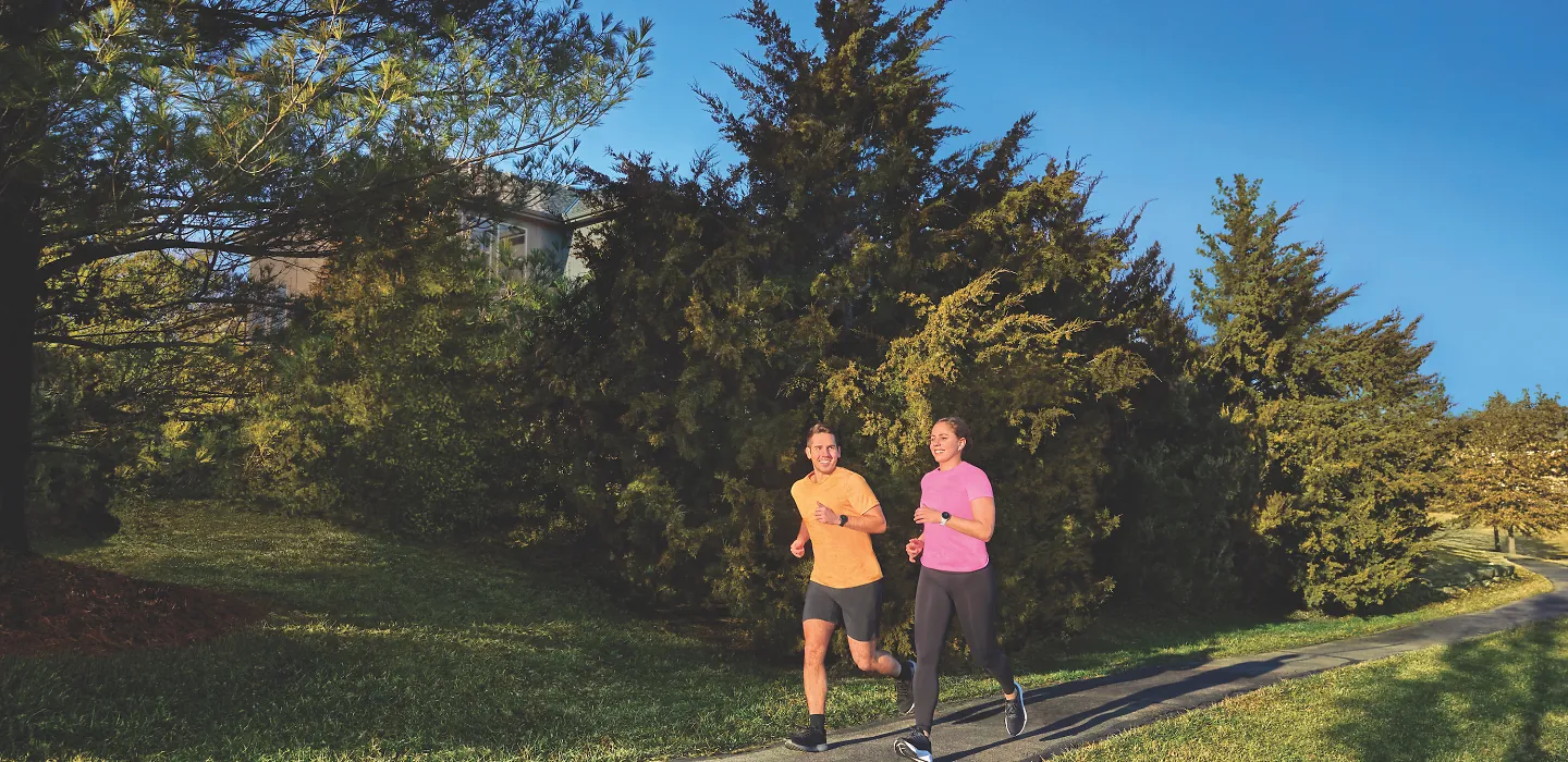 Two runners wearing Garmin watchs